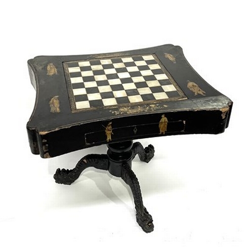 581 - A Chinese black lacquered and gilt games table, Qing Dynasty, inverted top decorated with gilt figur... 