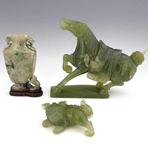 583 - Three Chinese jade type carvings, including a horse, a sushi dog and a ring handled vase on stand, 2... 