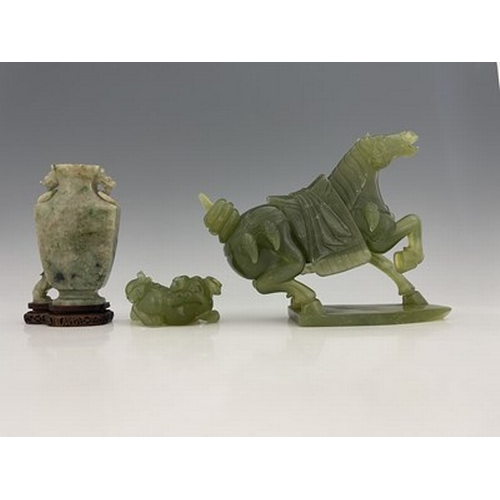 583 - Three Chinese jade type carvings, including a horse, a sushi dog and a ring handled vase on stand, 2... 