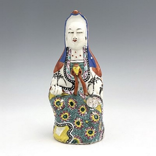 585 - A Chinese famille rose figure of Guanyin, polychrome enamelled and modelled in meditation, on stand,... 