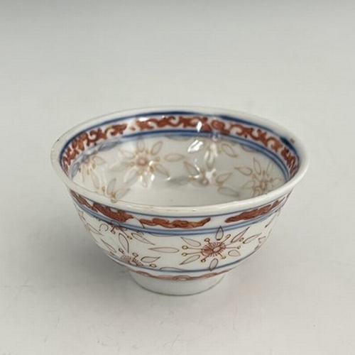 593 - A Chinese porcelain rice grain tea bowl, decorated in iron red with auspicious motifs and translucen... 