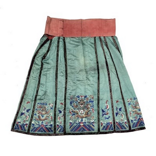 598 - A Chinese silk embroidered skirt and overcoat, Qing Dynasty, 19th Century, the overcoat in red with ... 