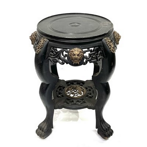 600 - A Chinese ebonised jardiniere stand, late Qing Dynasty, scroll pierced frieze, gilt metal beast mask... 