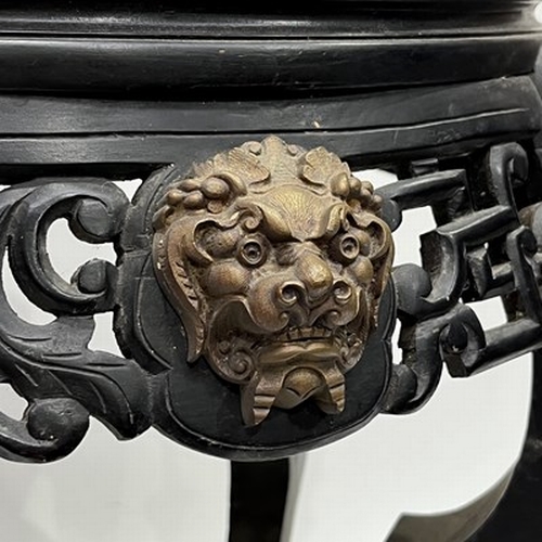 600 - A Chinese ebonised jardiniere stand, late Qing Dynasty, scroll pierced frieze, gilt metal beast mask... 