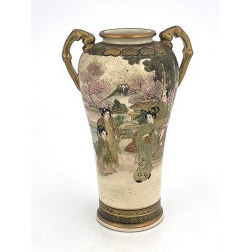 603 - A twin handled Japanese Satsuma vase, Meiji, shouldered form, painted in the round with figures in a... 