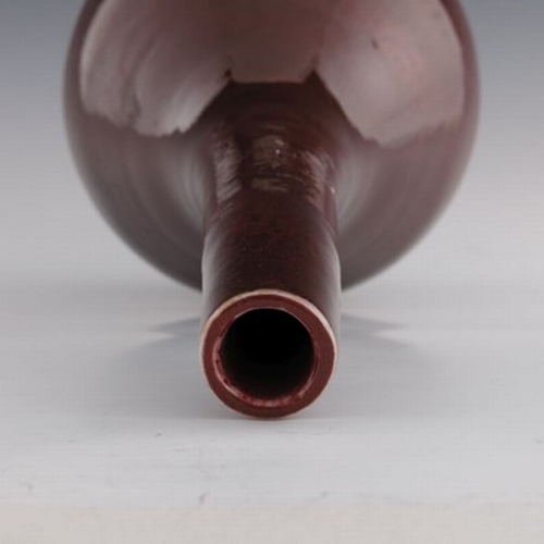 612 - A 19th century Chinese sang de boeuf glaze bottle vase, extended neck, 42cm high