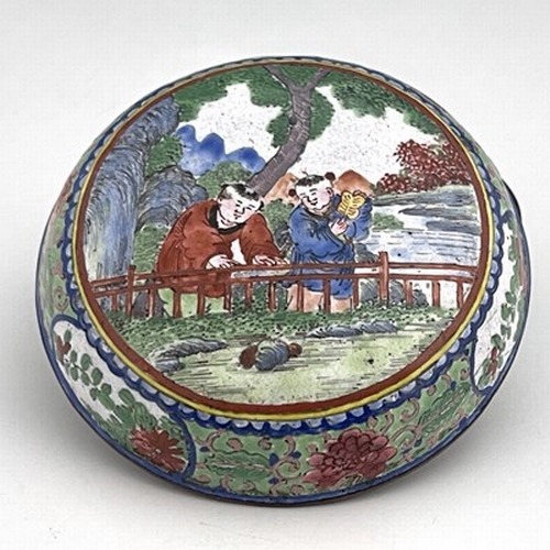 614 - A Chinese Canton enamelled box and cover, circular bun form, painted with two boys by a fence in a g... 