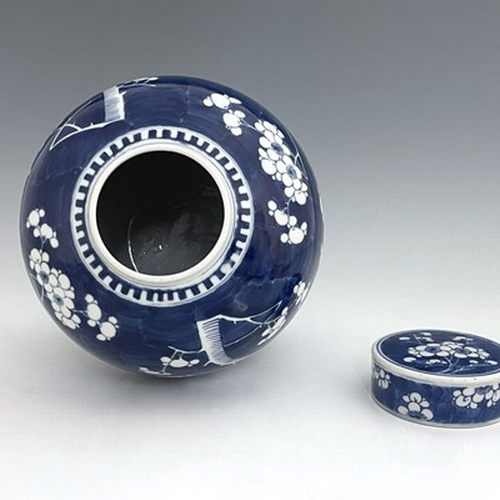 620 - A Chinese blue and white ginger jar and cover, painted with prunus blossom, 28cm high