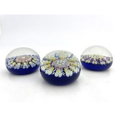 635 - Perthshire, three medium millefiori glass paperweights, pre 1978, blue grounds, central concentric f... 