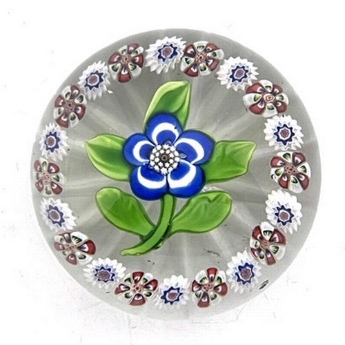 645 - Baccarat, a small floral and millefiori glass paperweight, 19th century, the central blue and white ... 