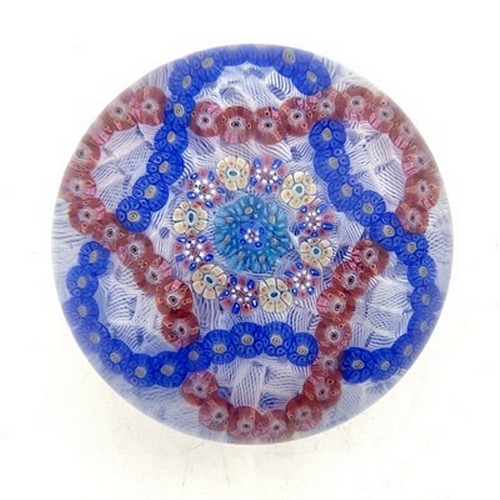 646 - Baccarat, a millefiori garland and latticinio ground glass paperweight, 1971, the central multi cogg... 