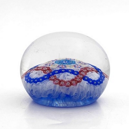 646 - Baccarat, a millefiori garland and latticinio ground glass paperweight, 1971, the central multi cogg... 