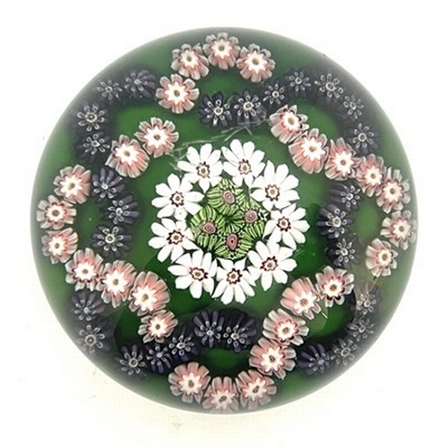 647 - Clichy, a millefiori garland glass paperweight, the central rosette of multi cogged canes and white ... 