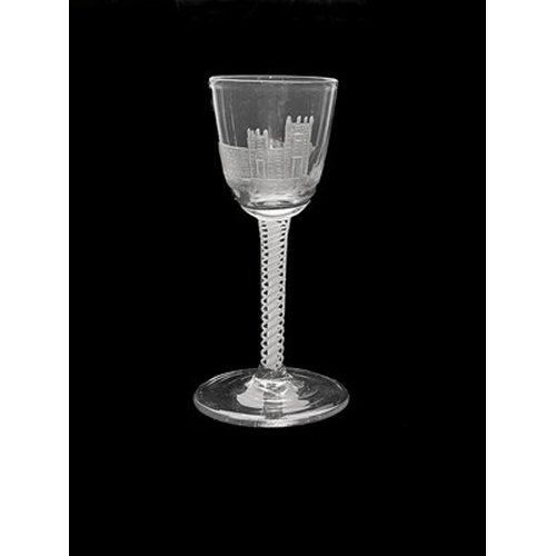 655 - An opaque twist wine glass, circa 1765, the round funnel bowl engraved with a church and disguised m... 