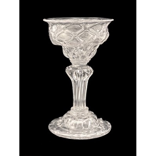 660 - A diamond moulded sweetmeat glass, circa 1740, the double ogee bowl with optic diaper lattice, on a ... 