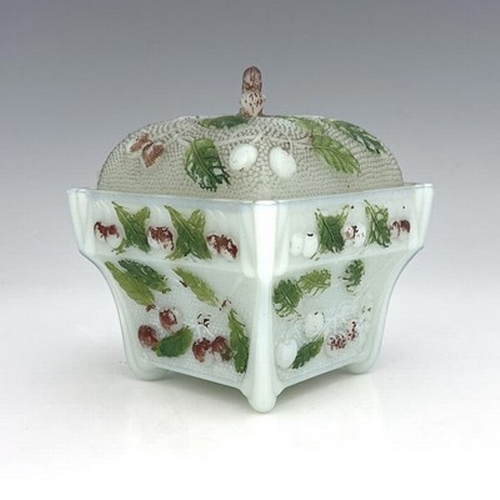 669 - An opaline glass sugar bowl and cover, relief moulded with cherries polychrome enamelld, square form... 