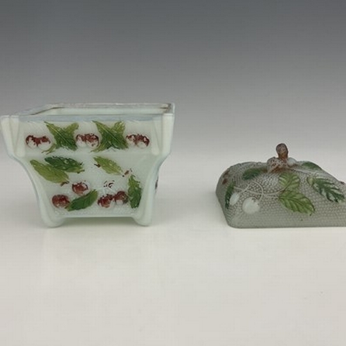 669 - An opaline glass sugar bowl and cover, relief moulded with cherries polychrome enamelld, square form... 