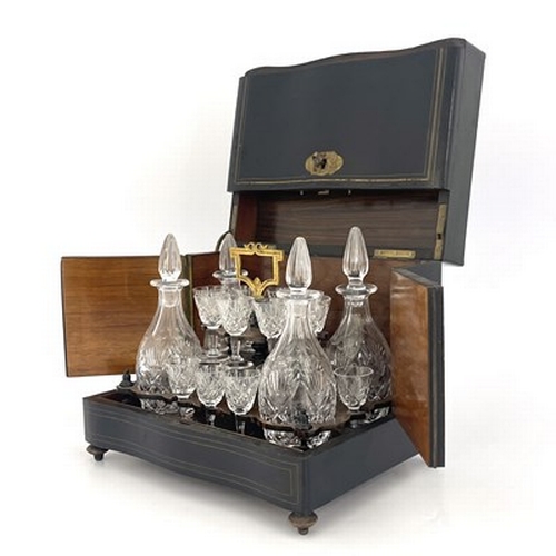 673 - An Edwardian boxed cut glass liqueur set, the rosewood stand of thistle cut decanters and stemmed gl... 