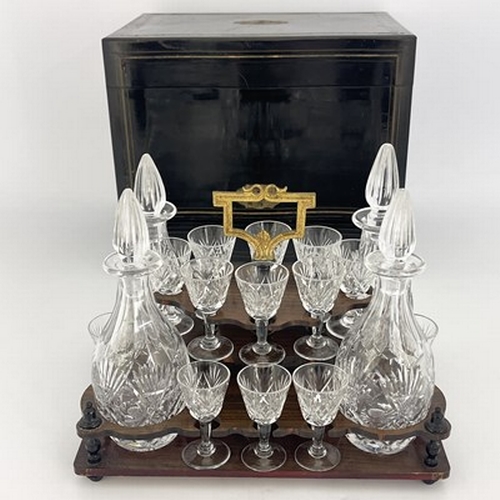 673 - An Edwardian boxed cut glass liqueur set, the rosewood stand of thistle cut decanters and stemmed gl... 