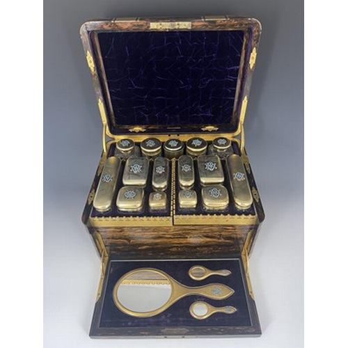 69 - A Victorian fitted dressing case, of rounded rectangular form in brass bound coromandel, with recess... 