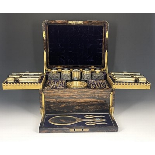 69 - A Victorian fitted dressing case, of rounded rectangular form in brass bound coromandel, with recess... 