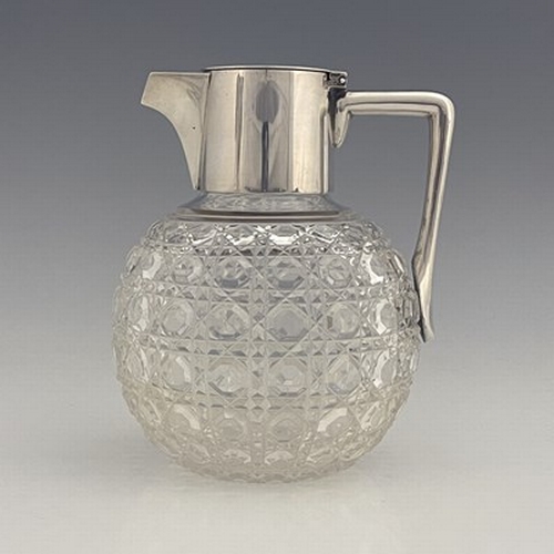 75 - After Christopher Dresser, an Aesthetic Movement silver and cut glass claret jug, Heath and Middleto... 