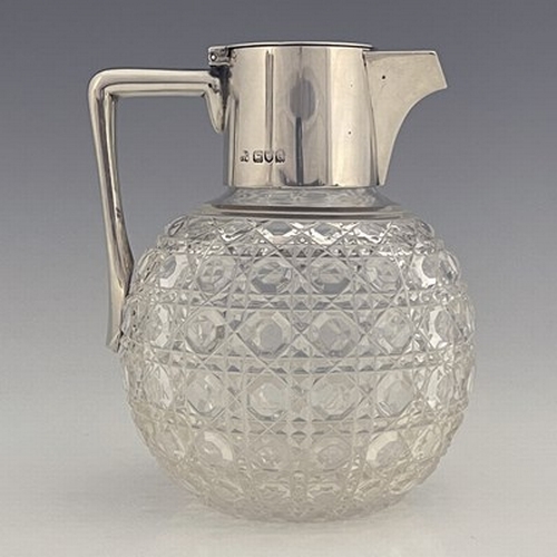 75 - After Christopher Dresser, an Aesthetic Movement silver and cut glass claret jug, Heath and Middleto... 