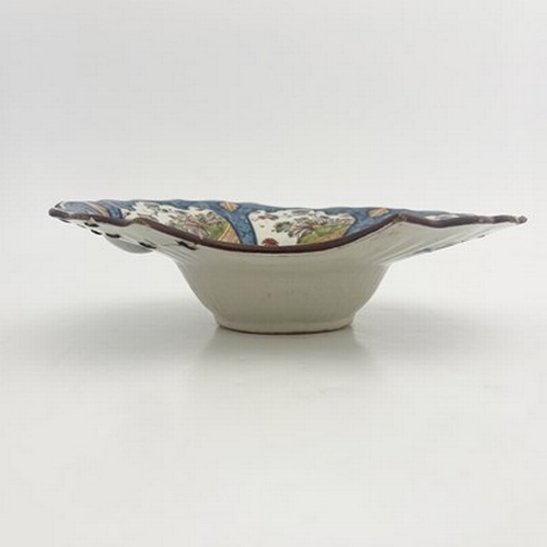 790 - A French Faience shaving shaving bowl, ogee rimmed, painted with Persian lappet cartouches of floral... 