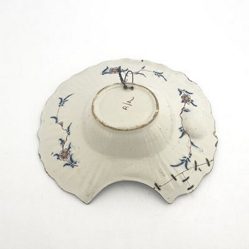 790 - A French Faience shaving shaving bowl, ogee rimmed, painted with Persian lappet cartouches of floral... 