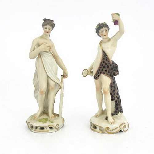 795 - A pair of 19th century German porcelain figures, Meissen sword marks, modelled as Bacchus and a muse... 