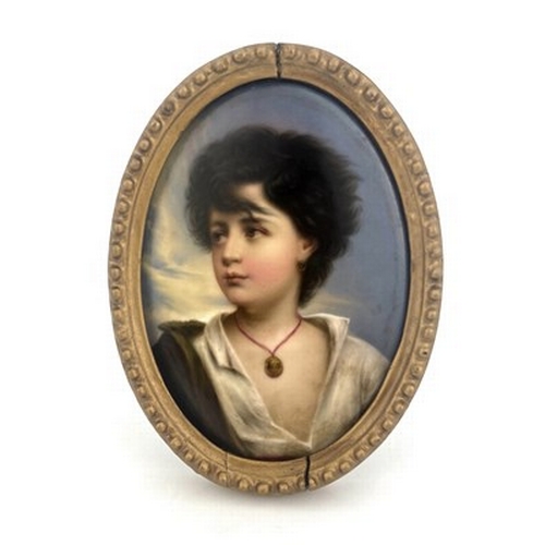 800 - A Berlin type porcelain plaque, oval form, painted with a gypsy boy with earring and pendant, 15.5cm... 