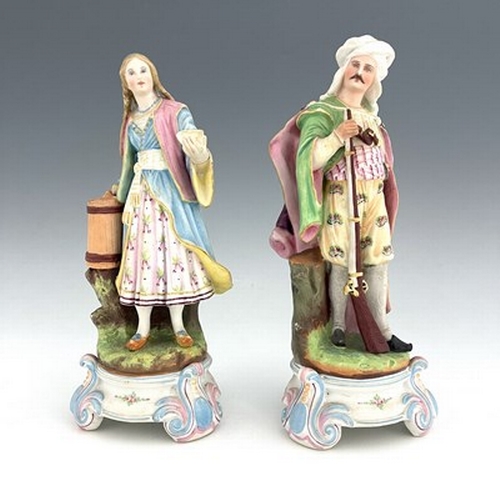 804 - A pair of bisque figures, 19th century, modelled as a Turkish soldier and woman, 28cm high (2)