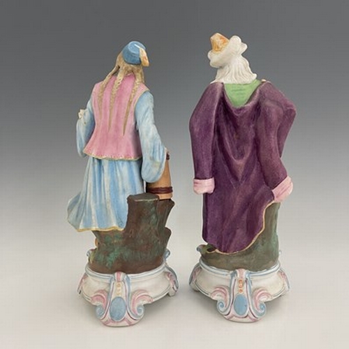 804 - A pair of bisque figures, 19th century, modelled as a Turkish soldier and woman, 28cm high (2)