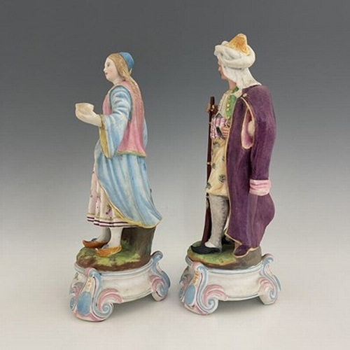 804 - A pair of bisque figures, 19th century, modelled as a Turkish soldier and woman, 28cm high (2)