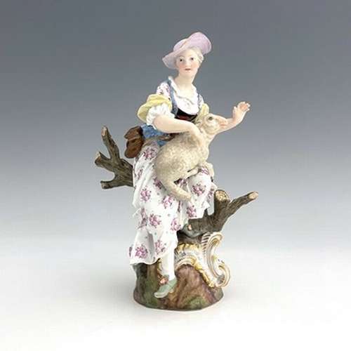 805 - A Meissen figure of a shepherdess, 19th century, 2122, modelled as a woman with a sheep, sitting in ... 