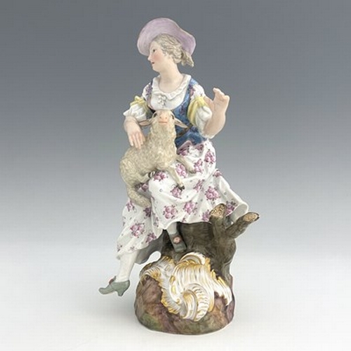 805 - A Meissen figure of a shepherdess, 19th century, 2122, modelled as a woman with a sheep, sitting in ... 