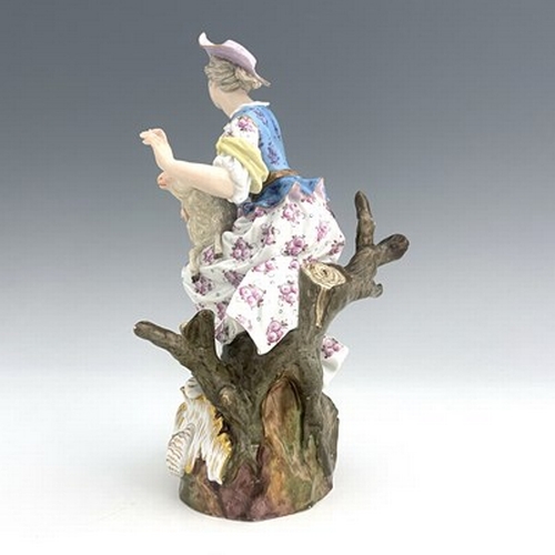 805 - A Meissen figure of a shepherdess, 19th century, 2122, modelled as a woman with a sheep, sitting in ... 