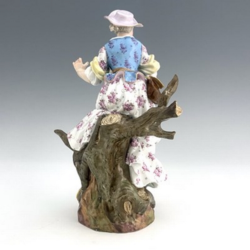 805 - A Meissen figure of a shepherdess, 19th century, 2122, modelled as a woman with a sheep, sitting in ... 