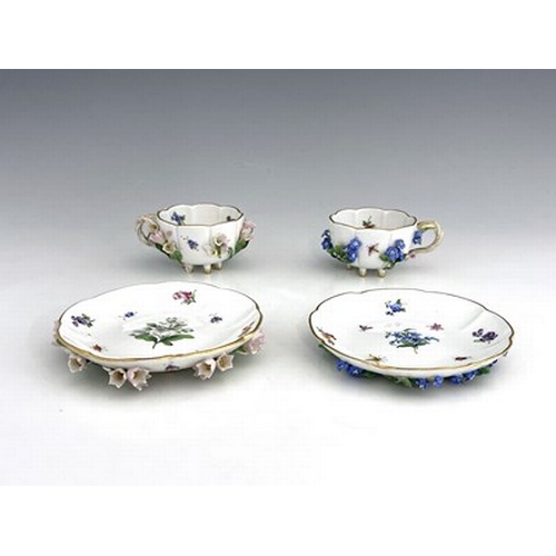 811 - Two Meissen florally encrusted tea cups and saucers, one with forget me nots, the other with campanu... 