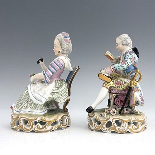 817 - A pair of Meissen type figures, probably late 18th century, model 137, modelled as a seated woman wi... 