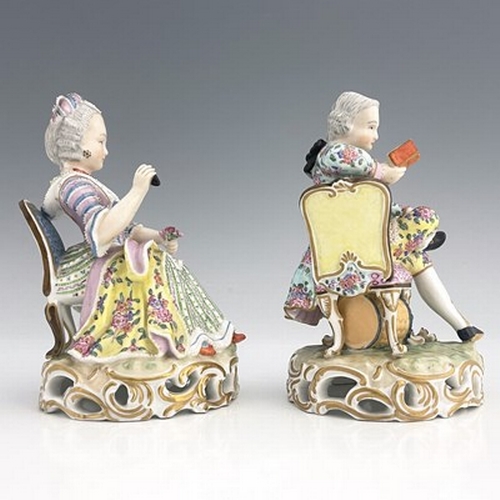 817 - A pair of Meissen type figures, probably late 18th century, model 137, modelled as a seated woman wi... 