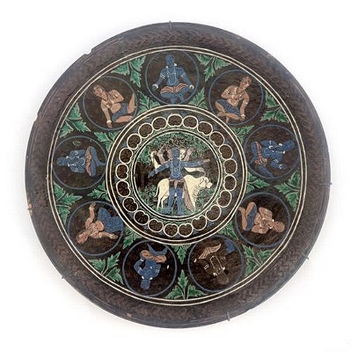 822 - Bombay School of Art, an art pottery charger, slip decorated with a central Hindu scene within round... 