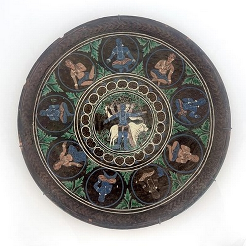 822 - Bombay School of Art, an art pottery charger, slip decorated with a central Hindu scene within round... 