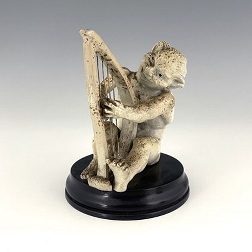 850 - Robert Wallace Martin for Martin Brothers, a stoneware musical imp figure, circa 1893, modelled play... 