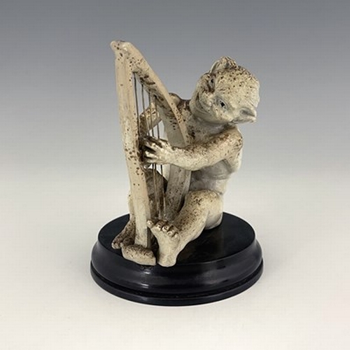 850 - Robert Wallace Martin for Martin Brothers, a stoneware musical imp figure, circa 1893, modelled play... 