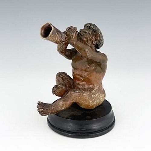 853 - Robert Wallace Martin for Martin Brothers, a stoneware musical imp figure, 1892, modelled playing a ... 