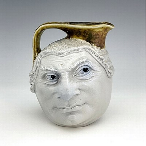 855 - Robert Wallace Martin for Martin Brothers, a stoneware characterful Barrister face jug, circa 1910, ... 