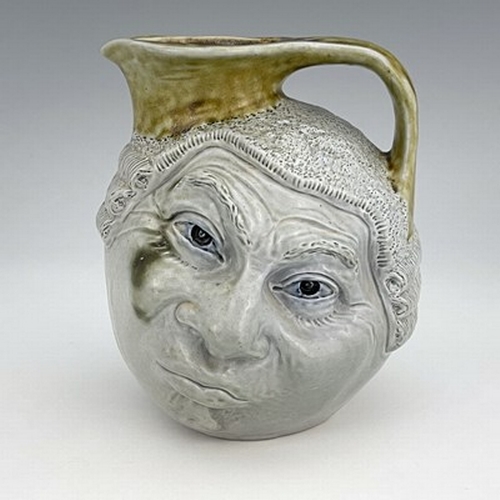 855 - Robert Wallace Martin for Martin Brothers, a stoneware characterful Barrister face jug, circa 1910, ... 