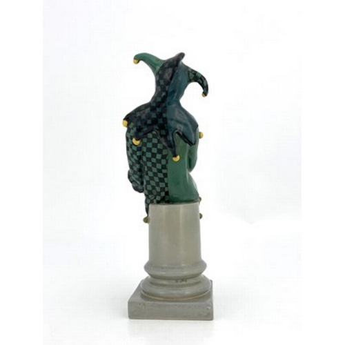 886 - Charles Noke for Royal Doulton, The Jester, figure HN 71, number 18, modelled on a column, green and... 