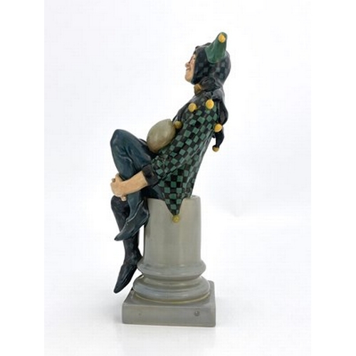 886 - Charles Noke for Royal Doulton, The Jester, figure HN 71, number 18, modelled on a column, green and... 